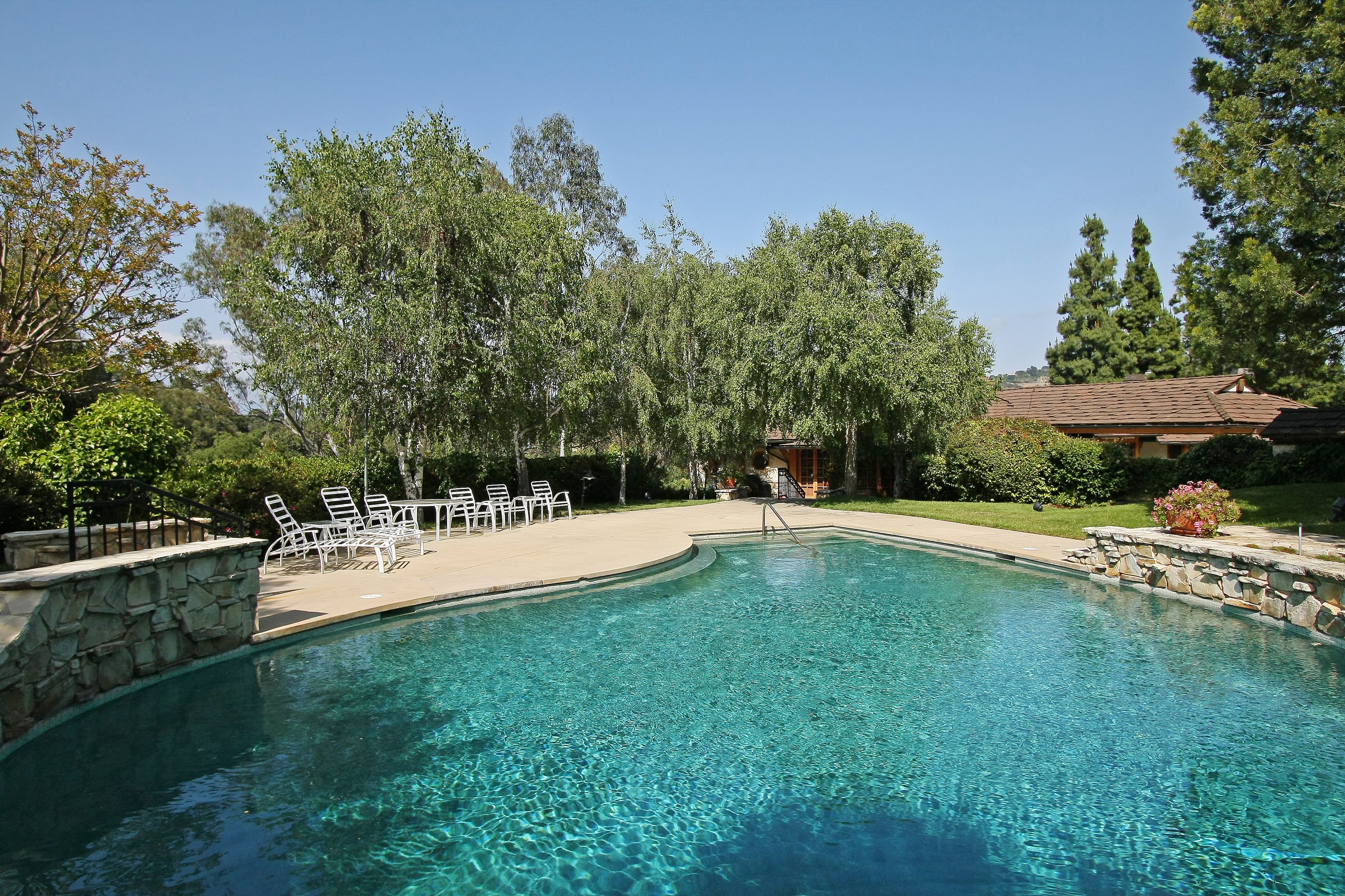 Swimming pool with lounge chairs at a Fryman Canyon Estates home